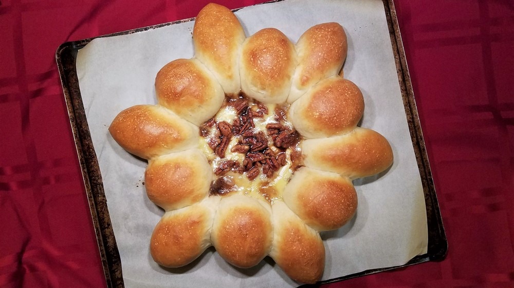 This bread art recipe has a big wow factor in terms of flavor and presentation, and it's easy to make. With oozy decadence from cheese and an optional sugar-nut glaze, it's great for a holiday party or dinner with guests.