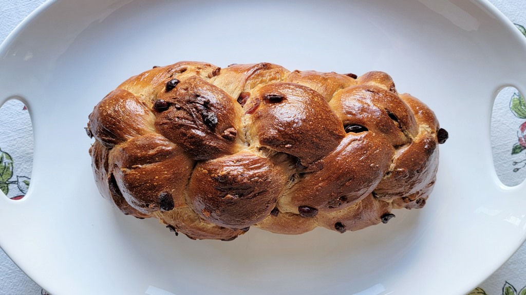 This braided bread is both beautiful and scrumptious. The texture is squishy-tender from the milk and all purpose flour; and the flavor is balanced and interesting with some whole wheat flour, plus the toasted pecans, dried cranberries, and hint of honey. It makes an impressive gift bread, but you'll want to make yourself one too.